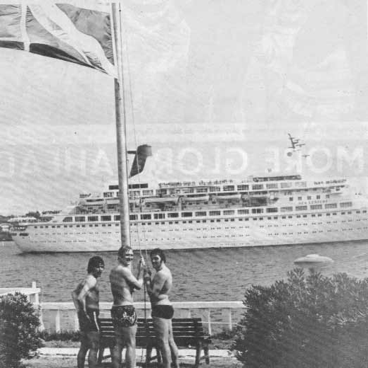 Macari, Hay and McCluskey lower the Union flag in salute to a passing ship.